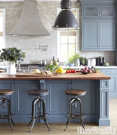 Cabinets and island are two different shades: Farrow & Ball's Down Pipe, a warm gray, on the cabinets, and Benjamin Moore's cooler Chelsea Gray on the island. The backsplash is acid-washed Seagrass limestone from Classic Tile. House Beautiful:...